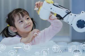Little girl playing with a robot arm