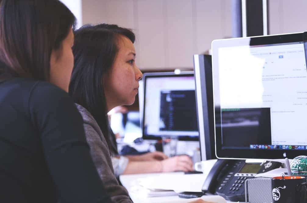 Two women working on a computer